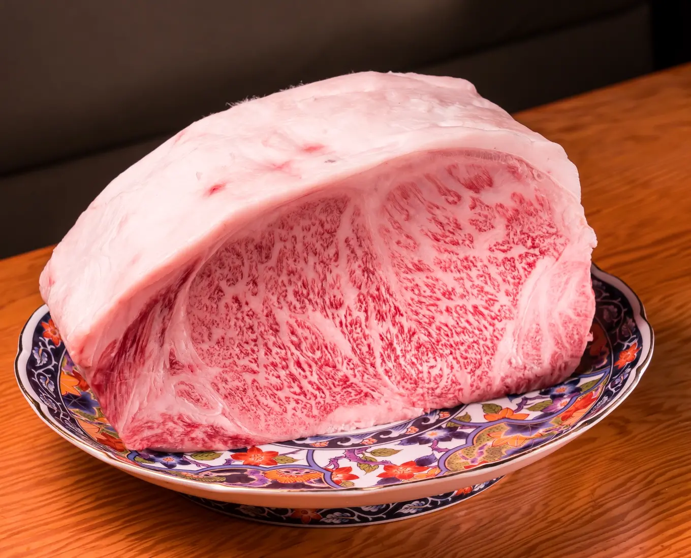 Premium marbled wagyu beef block on a decorative plate