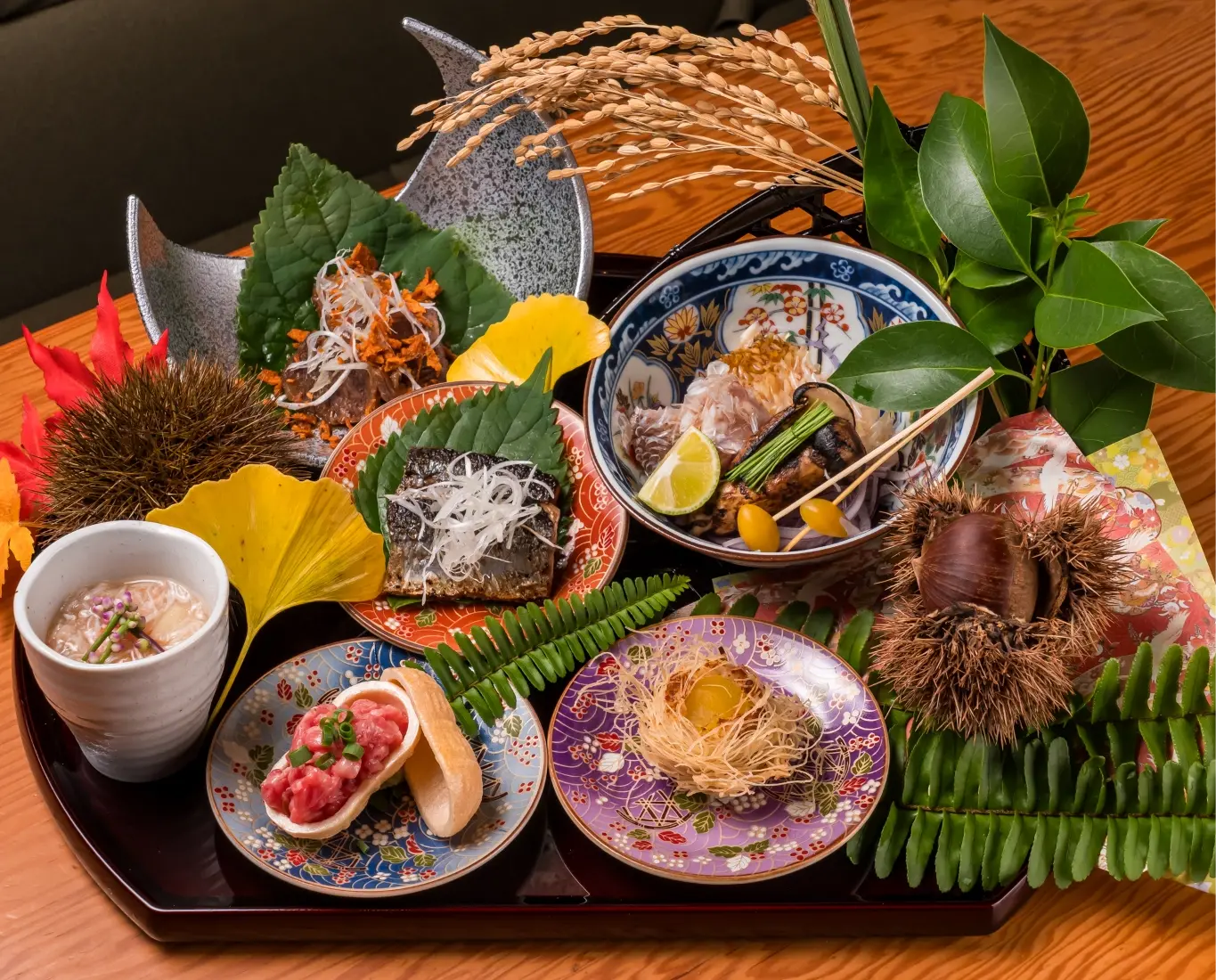 Seasonal Japanese appetizer assortment served on traditional plates