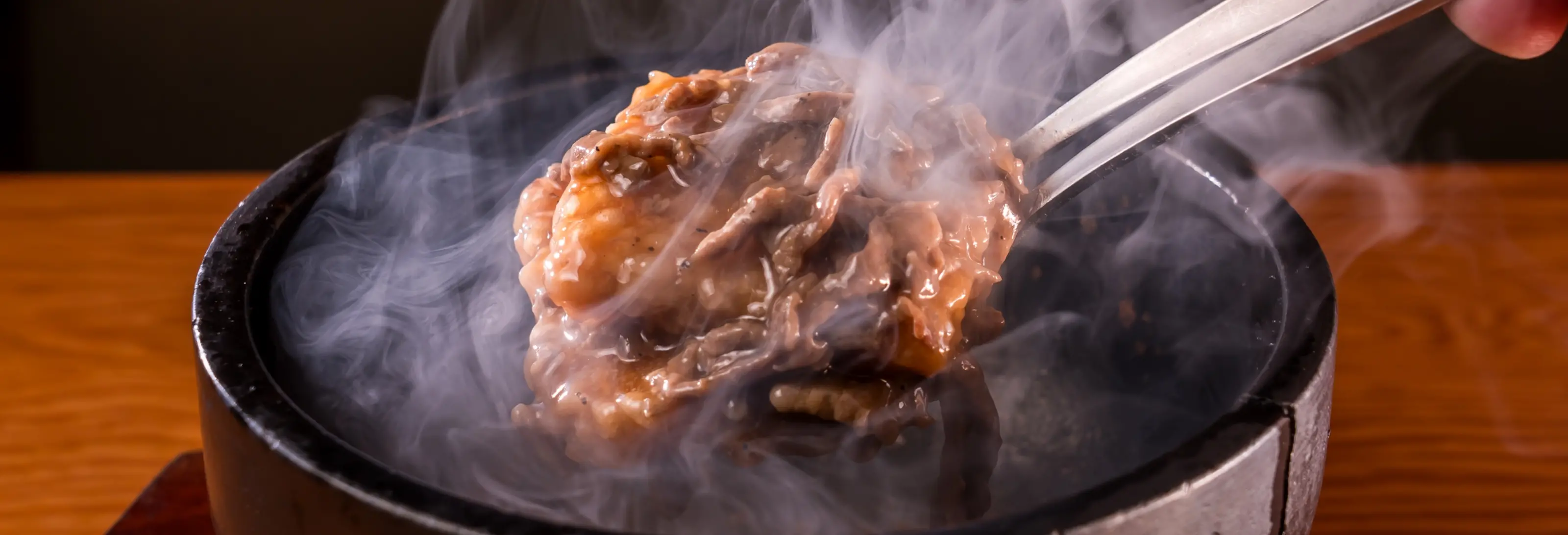 Sizzling stone-grilled wagyu beef with rising steam